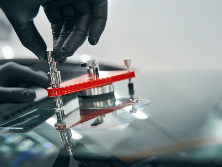 Repair Work On Cracked Car Windshield Closeup. Fixing Cracks In Window